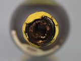 a close up view of a wine bottle with a hole in it