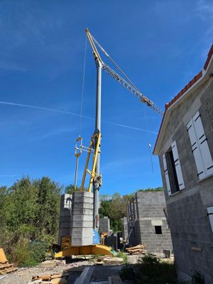 a crane that is standing on top of a building