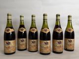 six bottles of wine lined up in a row on a table