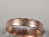 a close up photo of a wedding ring on a table