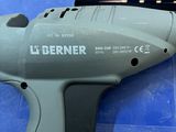 a cordless drill that is sitting on a blue surface