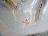 a close up of a white porcelain statue of a cat