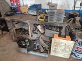 a wooden workbench filled with assorted items in a garage
