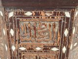 a close up of a wooden box with a carved design on it