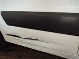 a white van that has a hole in the side of it