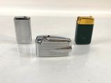 three lighters that are sitting on a table