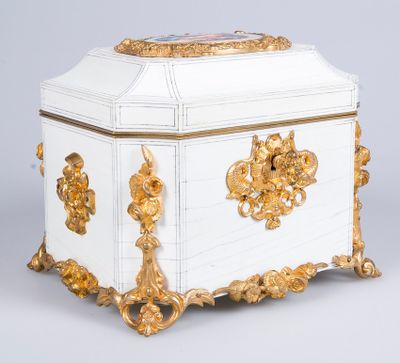 a white and gold box with gold decorations on it