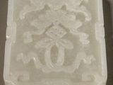 an old white jade box with a design on the front