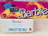 two boxes of barbie barbie dolls sitting on top of each other