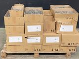 many boxes of nails on a pallet in a warehouse