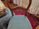 a chair that is sitting on a rug in a room