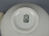 a close up of a white plate with a black design on it