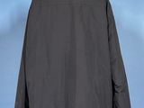 a black jacket on a mannequin stand against a blue background