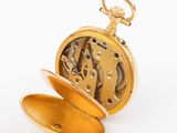 an image of a gold pocket watch on a white background