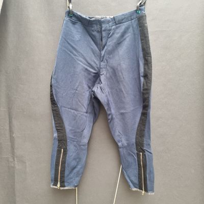 denim pants with zippers hanging on a clothes line on a hanger