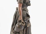 statue of a woman with a dog and a cat on a pedestal
