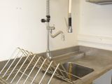 a stainless steel sink in a kitchen with a faucet