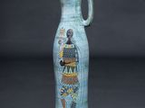 a blue vase with an image of a woman on it