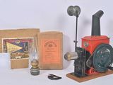 a red and black steam engine with a box and a lamp
