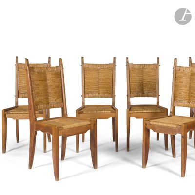 four wooden chairs with wicker seats and a cane back