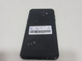 the back of a black cell phone with a barcode on it