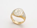 a close up of a gold ring with a monogram on it