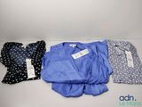 three shirts are lined up in a row on a table