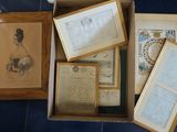 a box full of old papers and pictures on the floor