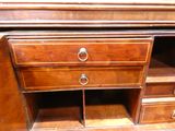 a wooden desk with drawers and a drawer underneath it