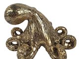 an image of a gold octopus statue on a white background