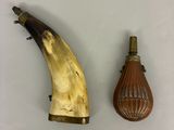 two pieces of horn and a bottle on the table