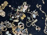 many different types of jewelry on a black surface