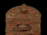 an image of a very old metal box with a face on it