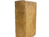 an old book sitting on top of a white surface