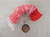 a red rope and a metal object on a table