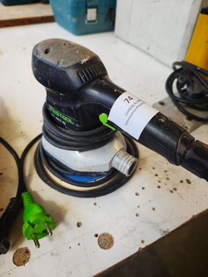 a sander that is sitting on a table with other tools