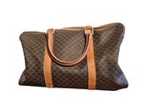 a brown and tan handbag on a white background