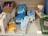 many boxes of toothpaste and toothbrushes on a shelf