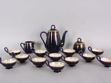a lot of cups and a teapot on the table