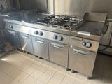 a large stainless steel stove in the middle of a kitchen