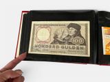 a hand holding a wallet with a note inside of it