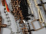 rosary and other religious items hang on a wall in a room