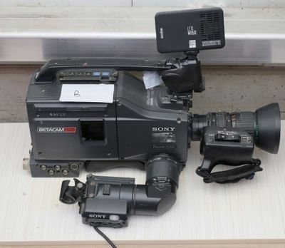 a camera that is sitting on a table next to a video camera