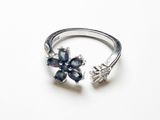 un gros plan d'une bague en argent ornée de fleurs