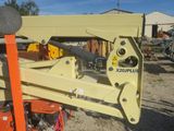 a yellow crane that is sitting in the dirt