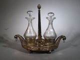 two glass vases sitting on top of a silver tray