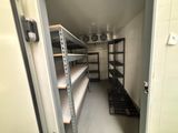 a small room with shelves and shelves in it