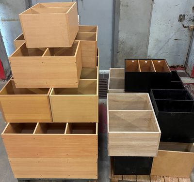 many wooden drawers that are stacked on top of each other