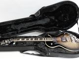 a guitar in a case on a white surface