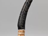 a black pipe with a gold ring on it